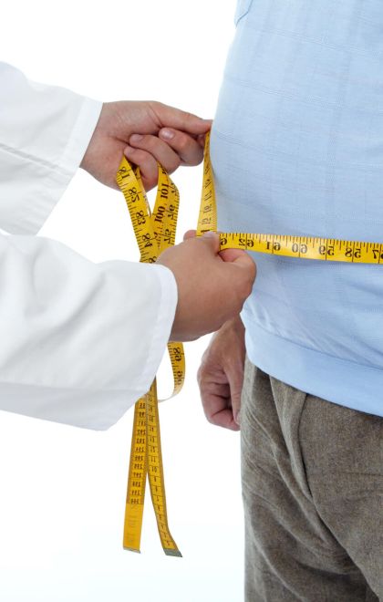obese man getting measured for weight loss surgery